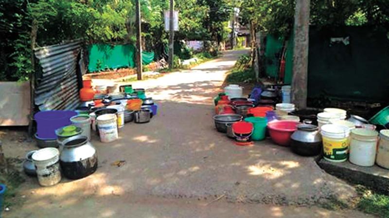 Vessels kept in front of water taps in Chavara.