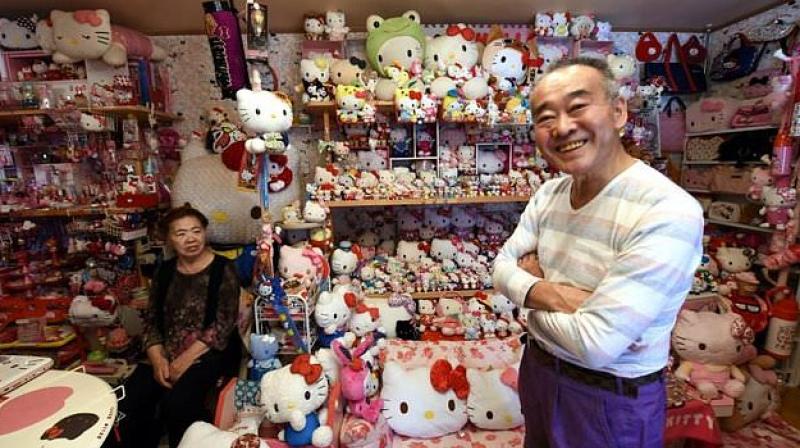 Retired Japanese police officer Masao Gunji (R), 67, poses next to his Hello Kitty collection -- the largest in the world. (AFP)
