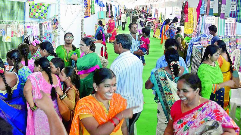 Visitors browse through the handicraft products on display at the expo at Swaraj Maidan in Vijayawada on Monday.  (DC)
