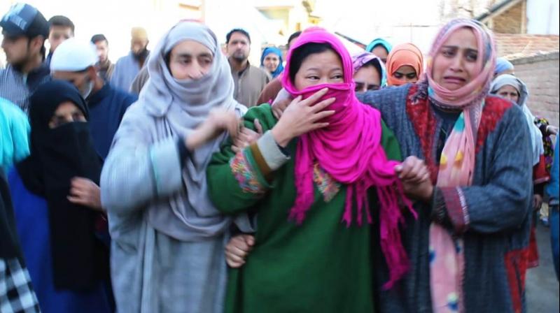 Saima (centre), wife of slain Abid Hussain Lone, being consoled by local women in J&Ks Pulwama. (Photo: Kashmir Life)