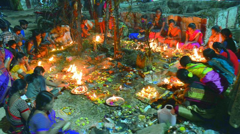 Women perform puja by lighting earthen lamps on Kartika Pournami at a temple in Musheerabad on Friday. The full moon day in the Hindu month of Kartika is considered to be auspicious day by the devotees of both Lord Shiva and Lord Vishnu.  (DC)