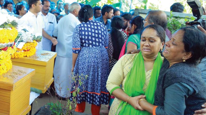 Grief-stricken relatives beside the bodies of Naliniamma, her son P.C. Vidhyasagar, and daughter P.C. Jayasree,  who died in the Delhi fire tragedy, at  their ancestral house at Cheranellor in Kochi on Wednesday.     (Arun Chandrabose)