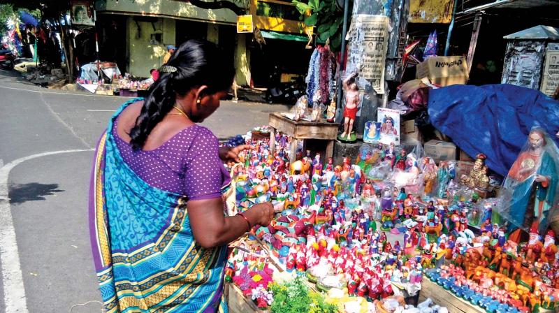 A woman checks out christmas dolls at a roadside stall in Puducherry. (Photo: DC)