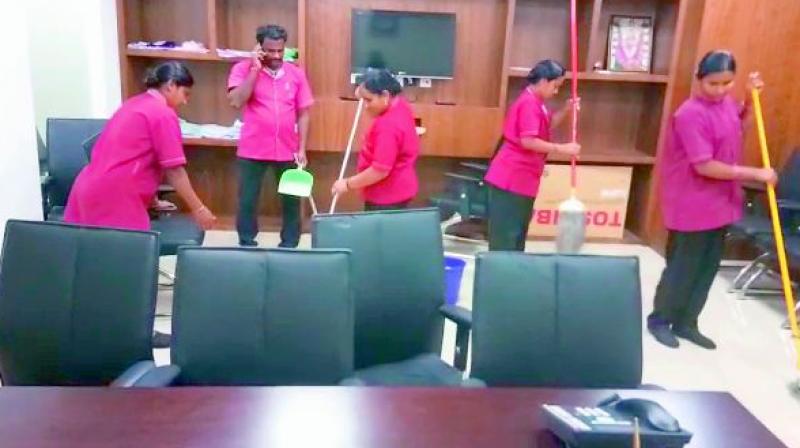 AP Secretariate sanitation staff clean the leaked rainwater from the roof at AP Secretariate building in Guntur district on Tuesday.