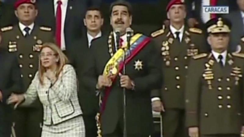In this still from a video provided by Venezolana de Television, Presiden Nicolas Maduro, center, delivers his speech as his wife Cilia Flores winces and looks up after being startled by and explosion, in Caracas, Venezuela, Saturday, Aug. 4, 2018. (Photo: AP)