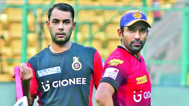 Stuart Binny (left) of RCB and Robin Uthappa of KKR during a training session on Saturday.(Photo: R. Samuel)