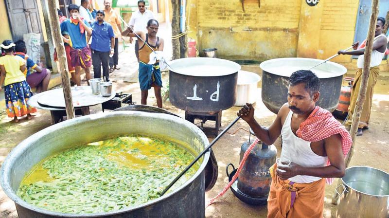 Volunteers involved in preparing food at Sethupathi Higher Secondary School Madurai on Saturday for grand feast on the eve of celestial wedding of Goddess Meenakshi with Lord Sundareswarar (Photo: DC)