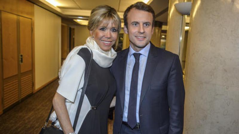 Emmanuel Macron, right, candidate for the 2017 French presidential elections and his wife Brigitte Macron. (Photo: AP)