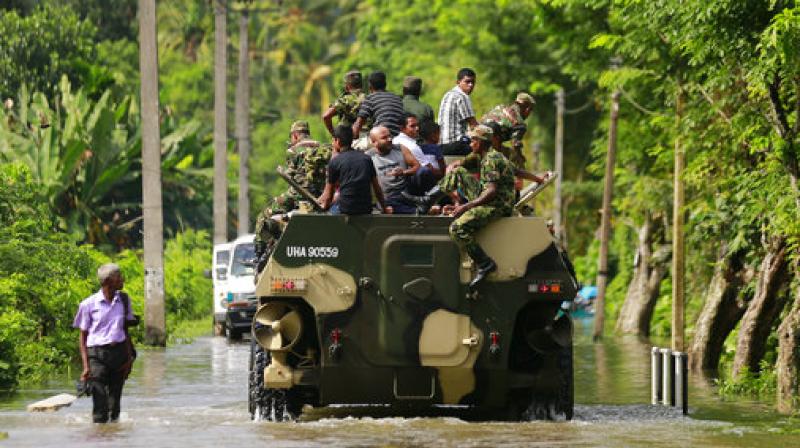 Sri Lankan army soldiers evacuate flood victims stranded at Agalawatte in Kalutara district, Sri Lanka on Saturday. (Photo: AP)