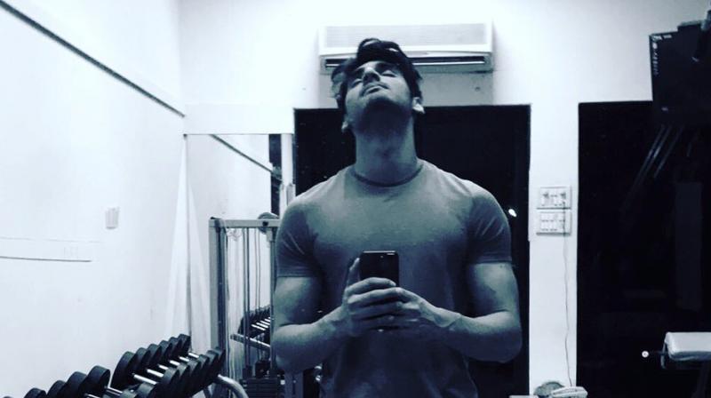 Ahan Shetty clicking a selfie in a gym.