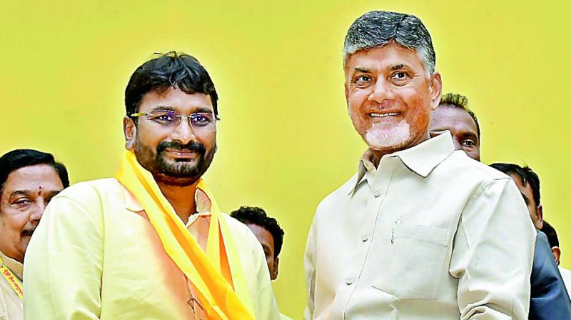 Chief Minister and TD national president N. Chandrababu Naidu puts on party kanduva on former minister and Congress leader Kondru Murali to welcome him into the party at Grievance cell near Vijayawada on Thursday. (Photo: DC)