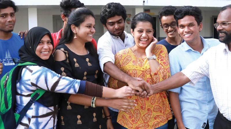 T.M. Purushothaman, principal of Seventh Day Adventist School, Kaloor, Kochi, congratulates winners of the ICSE and ISC exams from the school on Monday after  the results were declared. The school secured 100 per cent pass in both ICSE and ISC (Photo: ARUN CHANDRABOSE)