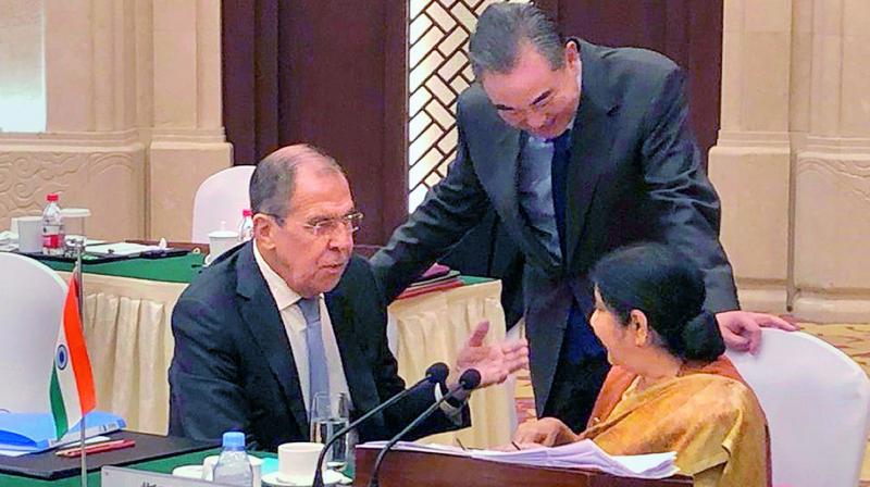 External affairs minister Sushma Swaraj with her Chinese counterpart Wang Yi and Russian counterpart Sergei Lavrov at the 16th foreign ministers meeting of Russia-India-China in China.	  PTI