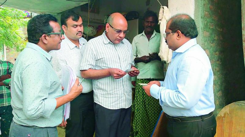 AP state chief electoral officer R.P. Sisodia and his team conducts field inquiry on fake voters registration in Ganapavaram village in Guntur district on Wednesday. (DC)