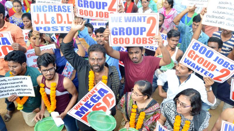 Members of AP Unemployed JAC protest demanding jobs at the GVMC Gandhi statue in Visakhapatnam on Wednesday.  (Deccan chronicle)