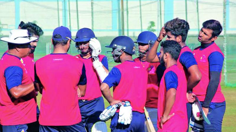 Mumbai coach Chandrakant Pandit (left) talks to his players ahead of their nets session on Saturday.