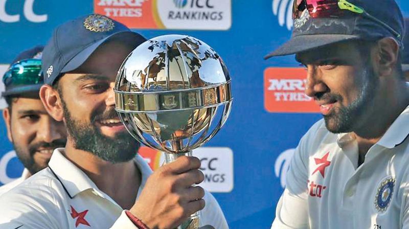 Virat Kohli and R. Ashwin hold the ICC Test championship mace. The duo played key role in helping India reach No.1