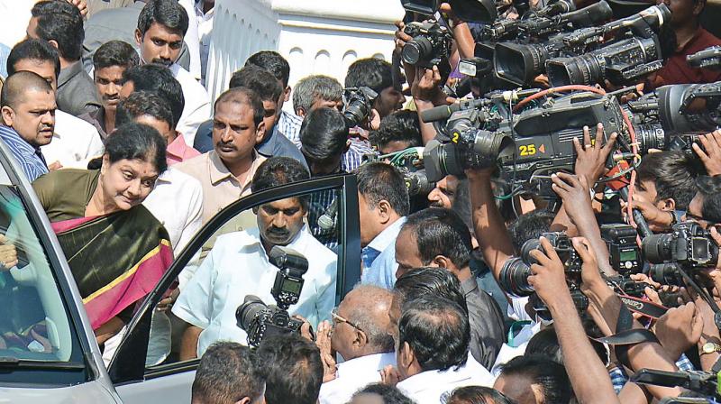 AIADMK general secretary, V.K. Sasikala, surrounded by media on Saturday, as she makes her way out of the party office in the car used by Jayalalithaa.	(Photo: DC)