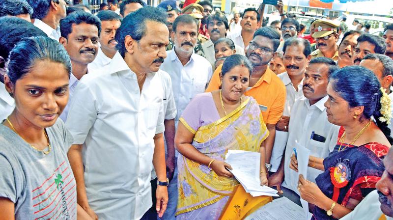 DMK Working President, M.K.Stalin checks the  voters list at a booth set up in a school, Kolathur  on Sunday. (Photo: DC)