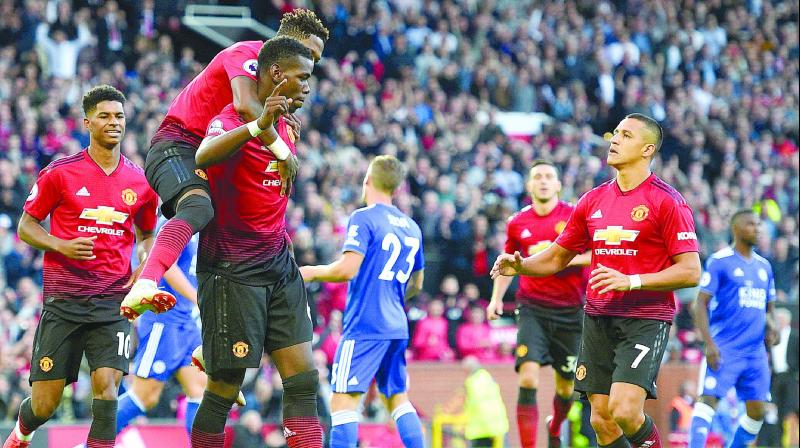 Manchester Uniteds Paul Pogba (centre) celebrates after scoring against Leicester City in their English Premier League match at Old Trafford in Manchester on Friday. The hosts won 2-1. (Photo: AFP)