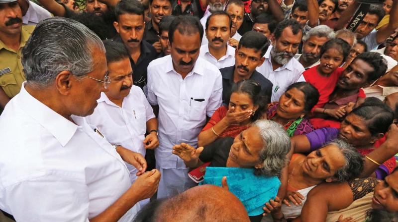 Chief Minister Pinarayi Vijayan along with Opposition leader Ramesh Chennithala  and Anwar Sadath, MLA, listen to grievances of flood victims at a relief camp at  Chengamanadu Govt HSS  in Kochi on Saturday (Photo: Arun Chandrabose)