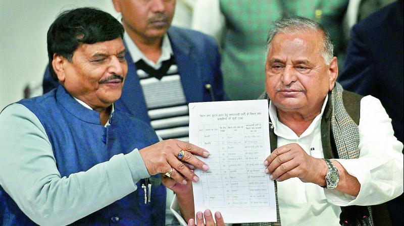 SP supremo Mulayam Singh Yadav  with partys UP President Shivpal Yadav showing the candidates list for UP Assembly elections at a press conference at the party office in Lucknow on  Wednesday. (Photo: PTI)