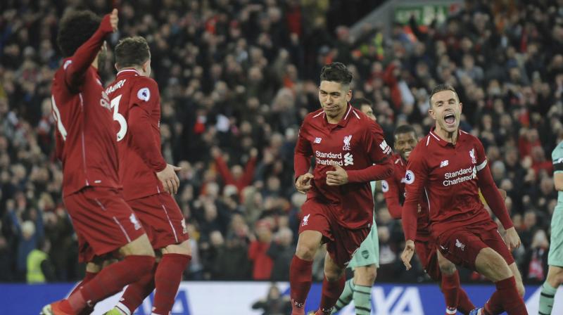 Liverpool extended their Premier League lead to nine points as Roberto Firminos hat-trick hammered Arsenal 5-1 at Anfield, while Tottenhams title challenge crumbled in a 3-1 home defeat to Wolves. (Photo: AP)