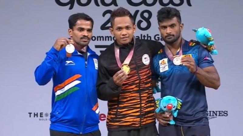 P Gururaja (left) opened Indias medal account on the first competition day of the 21st Commonwealth Games, claiming a silver in the mens 56kg category. (Photo: Twitter / IOA)/