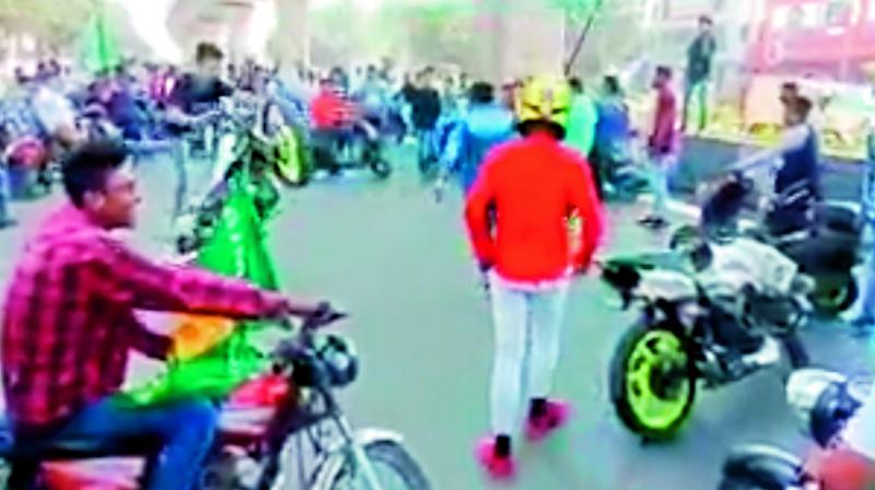 MIM supporters perform stunts at Malakpet Chaman, when party candidates went to file their nomination papers for the December 7 Assembly elections, on Thursday.