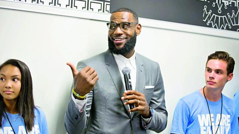 A file photo of LeBron James addressing students at the opening of a public school in Akron, Ohio.