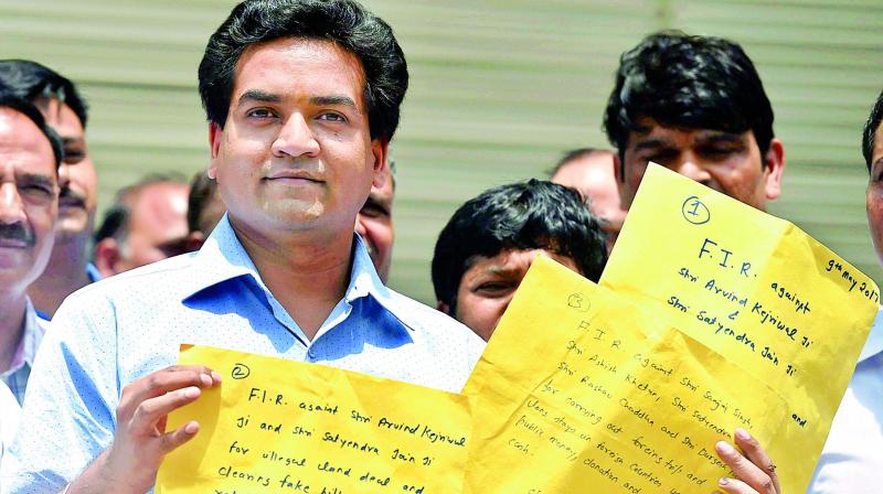 Sacked minister Kapil Mishra shows copies of the complaint at CBI headquarters on Tuesday. (Photo: PTI)