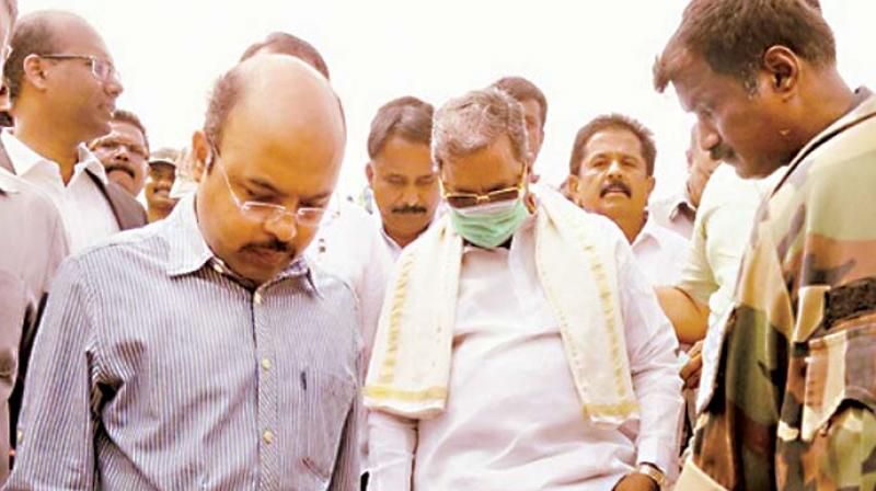 A file photo of Chief Minister Siddaramaiah with his son Dr Yathindra visiting the Varuna Assembly constituency in Mysuru district.