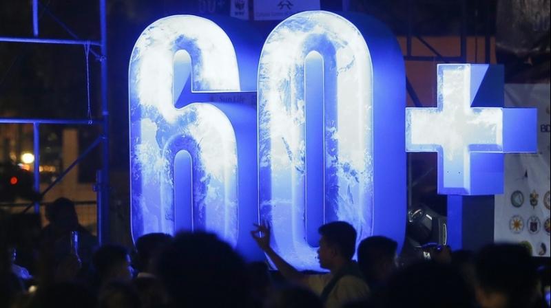 In countries around the world, at 8:30 p.m., people were switching off their lights for Earth Hour. (Photo: AP)