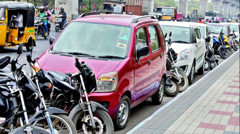 Two-wheelers parked in between four-wheelers at a metro station make it difficult for car owners to take out their vehicles.(Photo: P Surender Reddy)