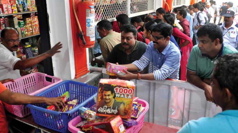 People throng a firecracker sales outlet in Kozhikode on Friday. Goods and Services Tax does not have much impact on the prices of crackers.	Venugopal