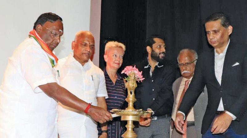 Puducherry Chief Minister V. Narayanasamy inaugurates the first Puducherry International Film Festival by lighting a lamp, on Wednesday. 	(Image: DC)