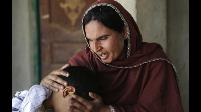 Kausar Parveen struggles through tears as she remembers the blood-soaked pants of her 9-year-old son, raped by a religious cleric. (Photo: AP)