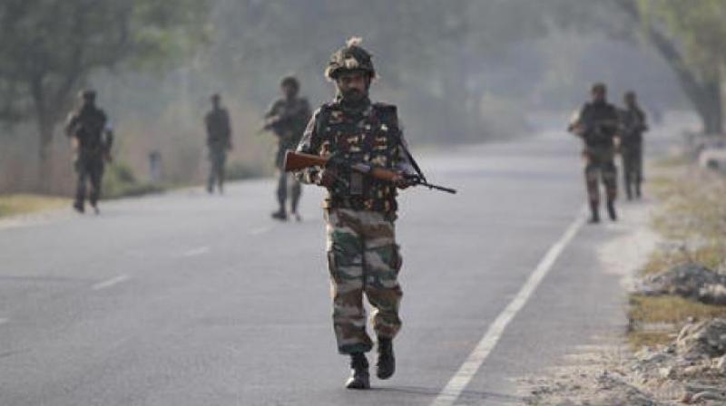 Soldiers patrol a highway outside an army base in Nagrota, about 15 kilometers from Jammu. (Photo: PTI)