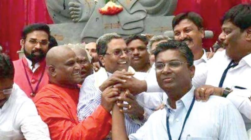 A file photo of Congress Satish Jarkiholi with senior party leaders Siddaramaiah and H.C. Mahadevappa