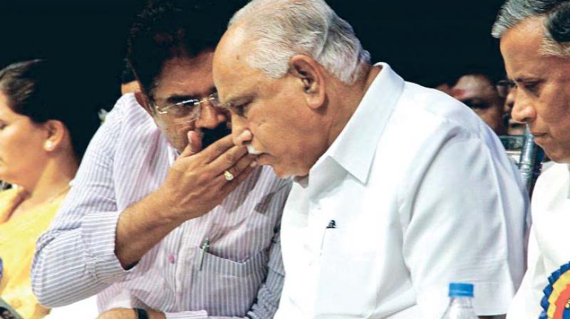 A file photo of state BJP chief B.S. Yeddyurappa with party MLA R. Ashok