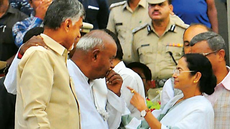 JD(S) supremo H.D. Deve Gowda with Andhra Pradesh Chief Minister N. Chandrababu Naidu and West Bengal Chief Minister Mamata Banerjee at the swearing-in ceremony in Bengaluru on Wednesday. (Photo:R. Samuel)