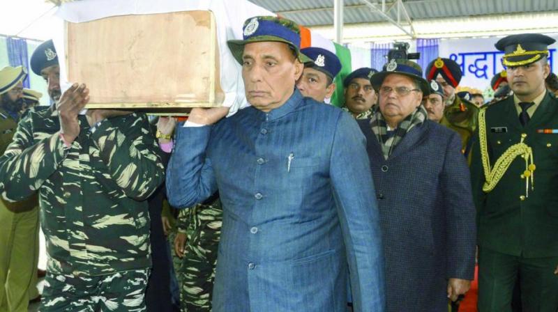 Union home minister Rajnath Singh shoulders the coffin of a slain CRPF jawan in Budgam on Friday. (Photo: PTI)