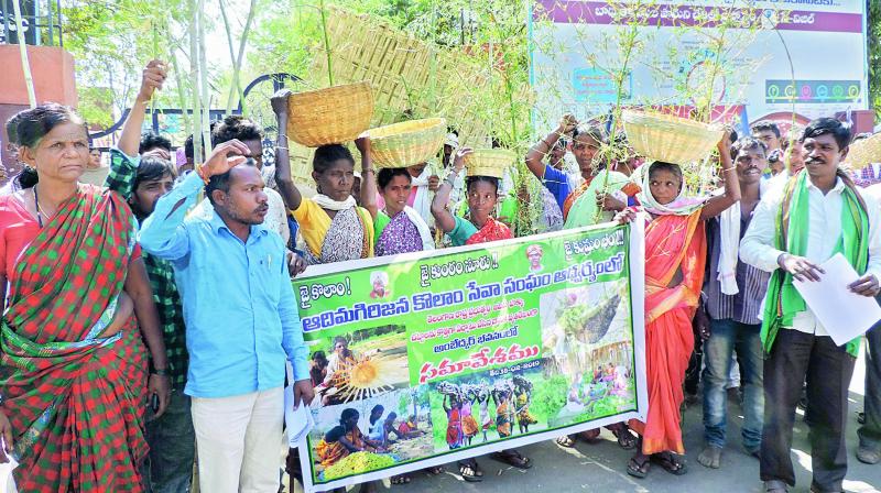 Vulnerable Primitive Tribal Groups including Kolams stage a dharna in front of the collectorate in Adilabad town carrying bamboo and bamboo made items against forest officials not allowing them into forests on Monday.  	DC