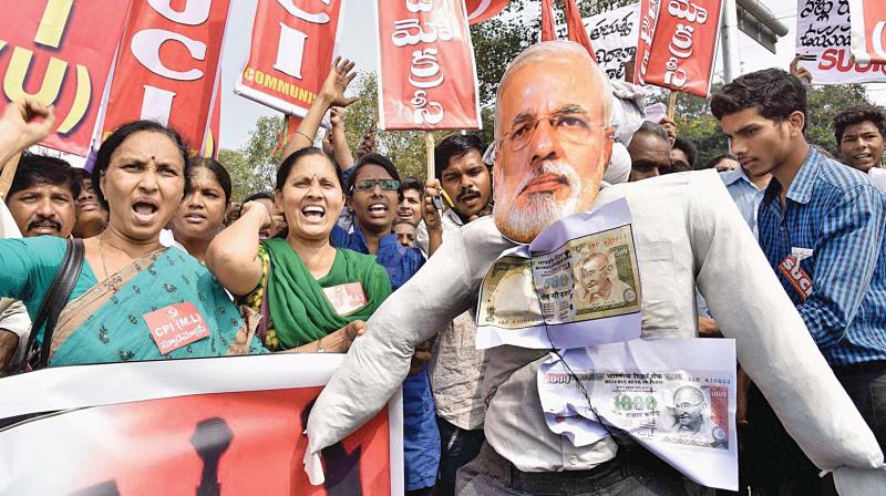Left activists and leaders shout slogans and carry an effigy of PM Narendra Modi during a protest against demonetisation, in Hyderabad.