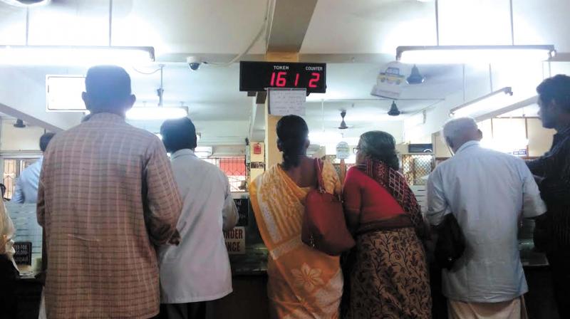 With just a single counter, senior citizens had to wait for long queues at some of the banks in the city on Saturday. (Photo: DC)