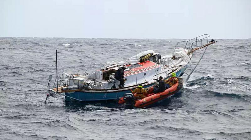 In this photo provided by the Australian Maritime Safety Authority, Indian sailor Abhilash Tomy, left, transfers to an inflatable boat as rescuers collect him from his damaged yacht, Thuriya, in the southern Indian Ocean. (Photo: AP)