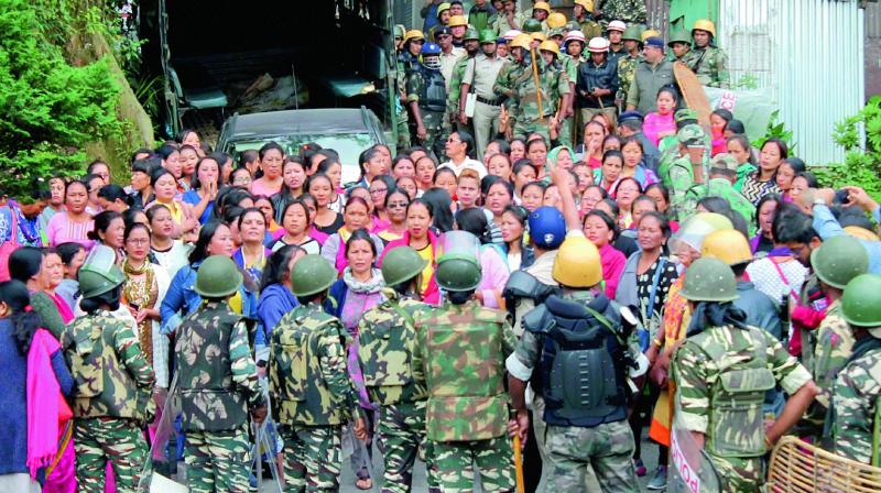 Security forces personnel during clashes with Gorkha Janamukti Morcha supporters in Darjeeling on Thursday. (Photo: PTI)