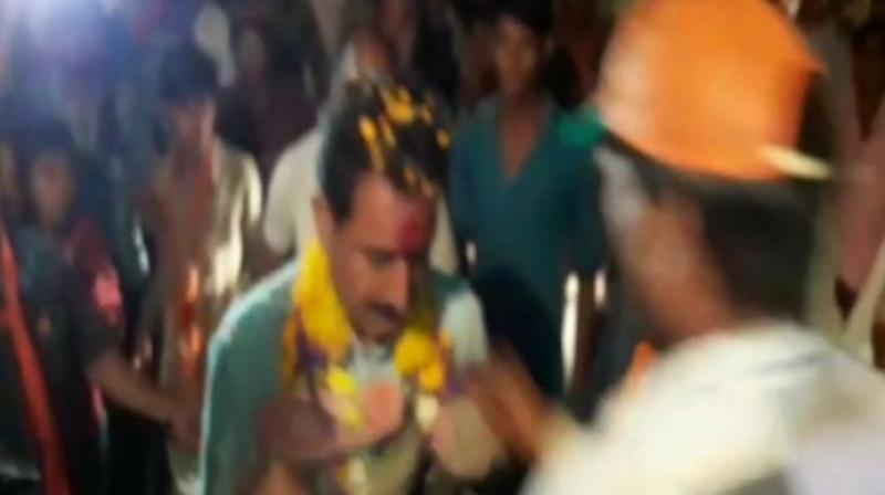 In a video of the incident, a man can be seen greeting BJP MLA Dilip Shekhawat with a garland of shoes. (Photo: ANI)