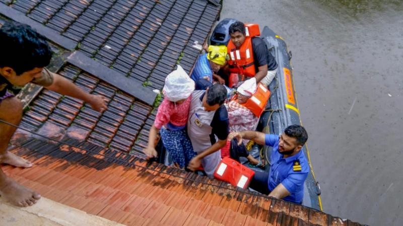 Rescue teams evacuate people from flood affected areas, to relief camps at Kottayam district in Kerala on Monday. (Photo: PTI)