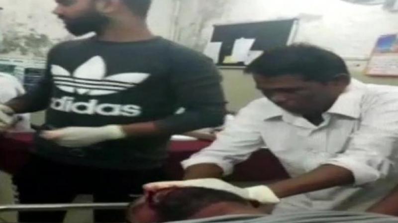 The sweeper (right, in white shirt) in question was involved in a similar incident three months ago when he was filmed giving stitches to another patient. (Photo: ANI)
